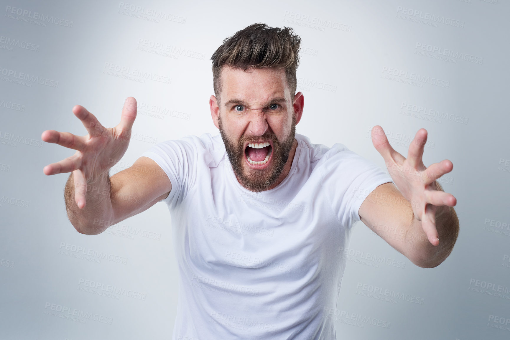 Buy stock photo Portrait of an angry young man losing his temper in studio