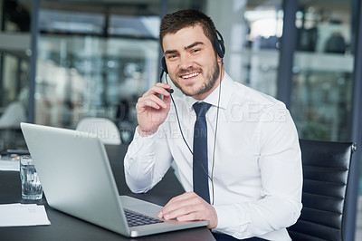 Buy stock photo Portrait of a young customer service representative wearing a headset while sitting at his workstation in an office