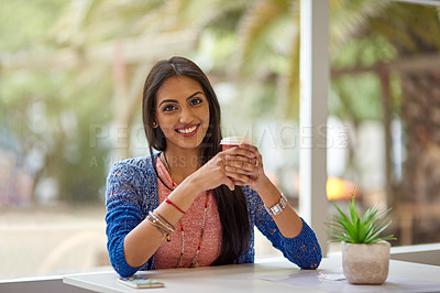 Buy stock photo Portrait of an attractive young woman drinking coffee in a coffee shop