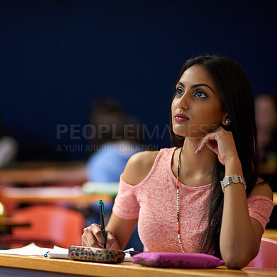 Buy stock photo Woman, college and student with thinking in lecture hall for lesson, teaching and learning on campus. Female person, university and writing notes for study or revision for exam, test and assignment