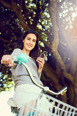 Buy stock photo Bicycle, cycling and woman with portrait, outdoor and activity with smile and cellphone. Girl, happiness and alternative transport with carbon neutral travel, eco friendly and smartphone on bike