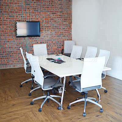 Buy stock photo Shot of a conference table and chairs in an empty boardroom