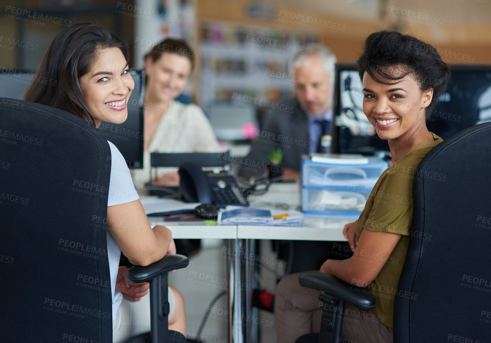 Buy stock photo Portrait of a group of coworkers sitting at their workstations in an office