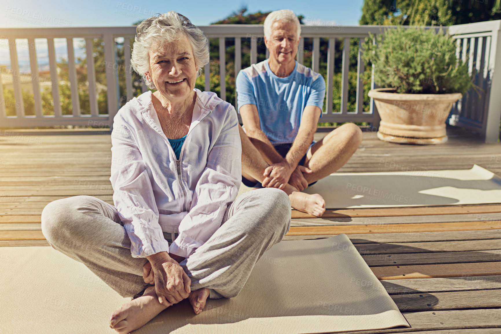 Buy stock photo Portrait of a senior couple doing yoga together on their patio outside