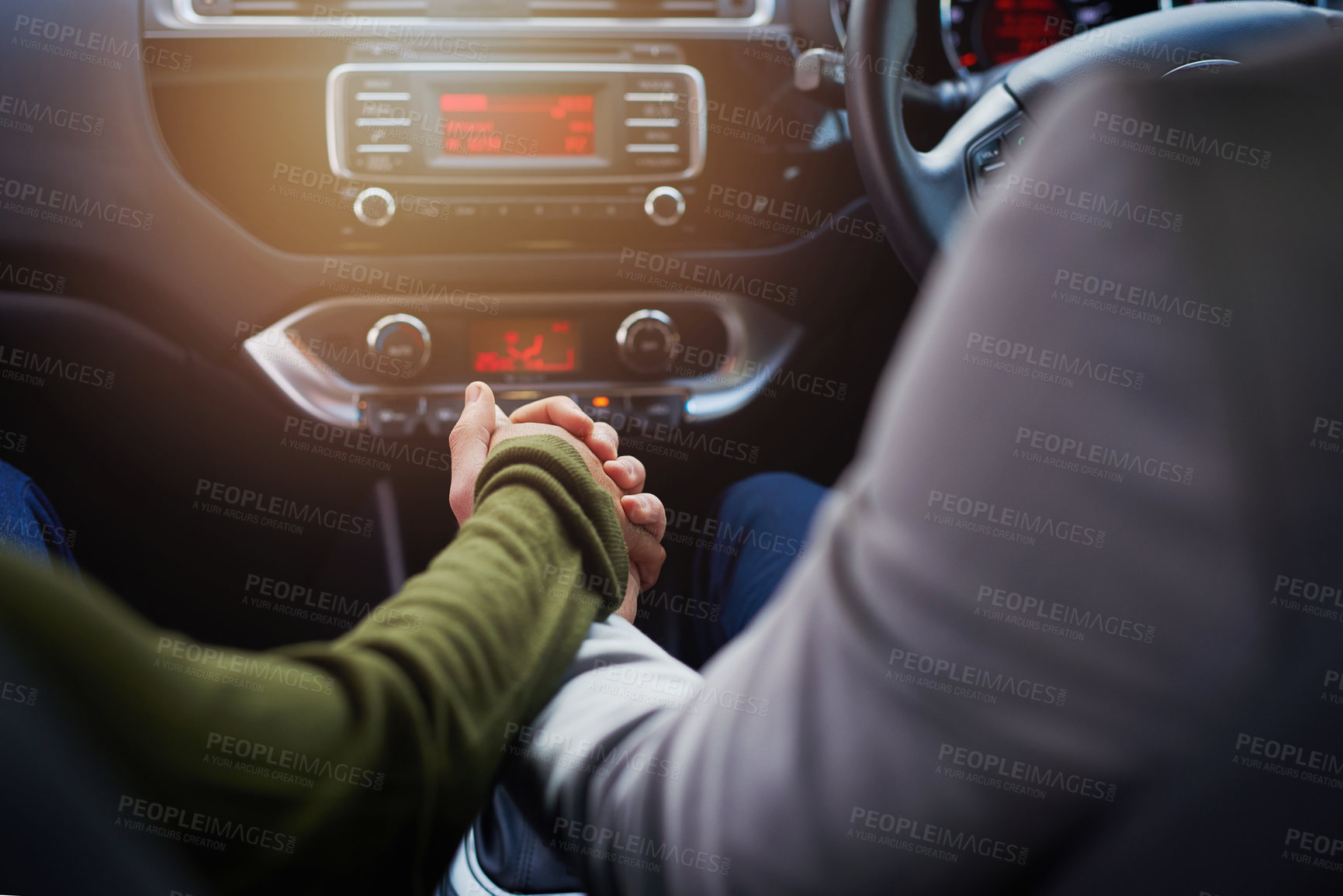 Buy stock photo Closeup shot of a couple holding hands while driving in a car