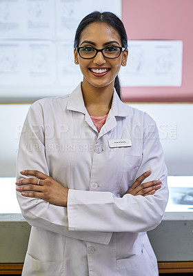 Buy stock photo Portrait of a young female dentist standing in her office