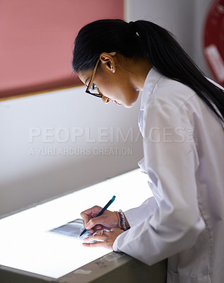 Buy stock photo Cropped shot of a young female dentist analysing an x-ray