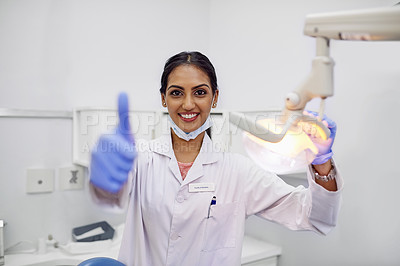 Buy stock photo Dentist, portrait and thumbs up in office with smile for support, care and good dental health. Woman, equipment and happy with hand gesture for motivation, approval and success in oral hygiene