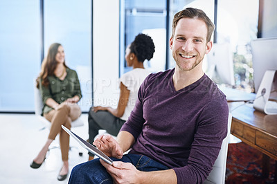 Buy stock photo Portrait of a designer sitting in an office with his colleagues in the background