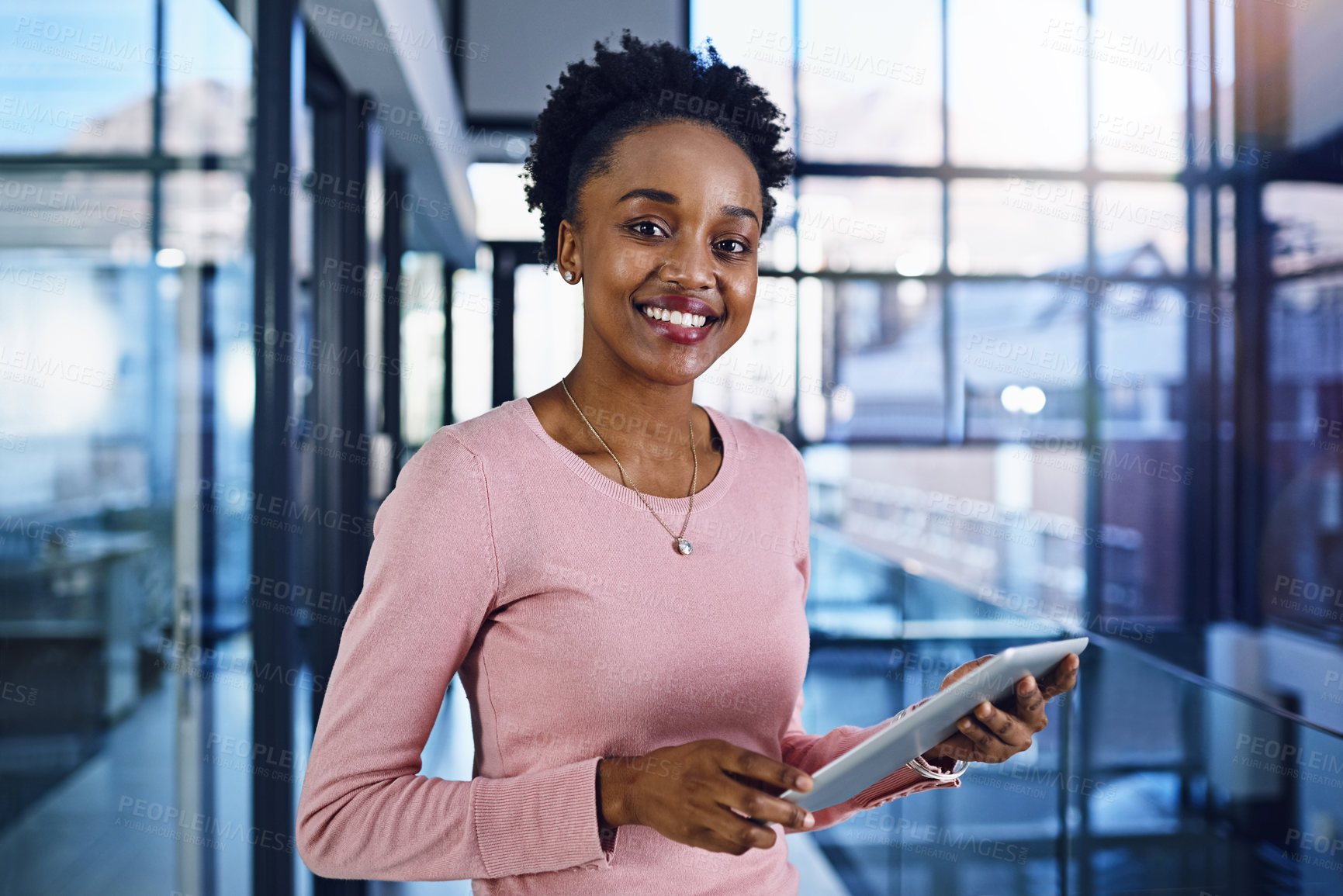 Buy stock photo Portrait of a young businesswoman working on a digital tablet in the office