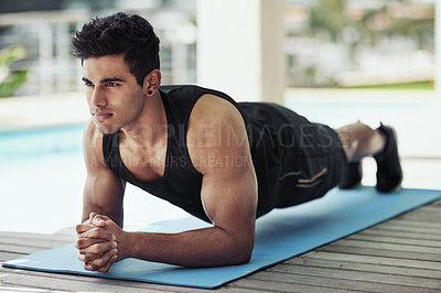Buy stock photo Shot of a young man planking during his workout at home