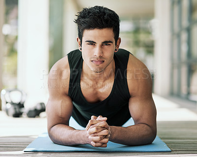 Buy stock photo Portrait of a young man planking during his workout at home