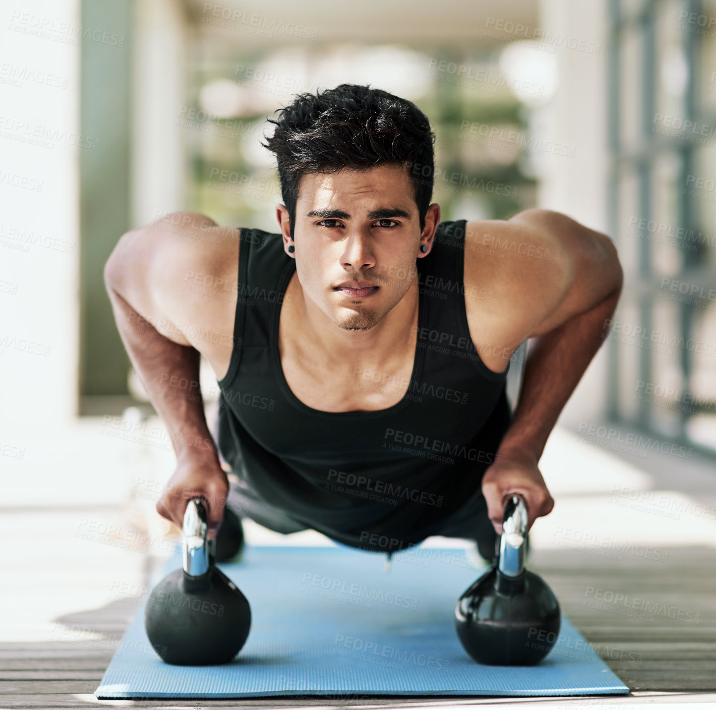 Buy stock photo Portrait of a young man doing pushups with dumbbells at home