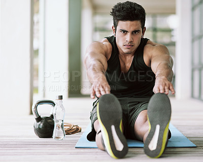 Buy stock photo Portrait of a young man stretching before his workout at home
