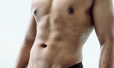 Buy stock photo Cropped shot of an unidentifiable young man's abdominal muscles