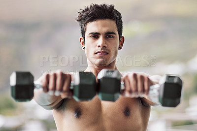 Buy stock photo Portrait of a shirtless young man working out with dumbbells outside