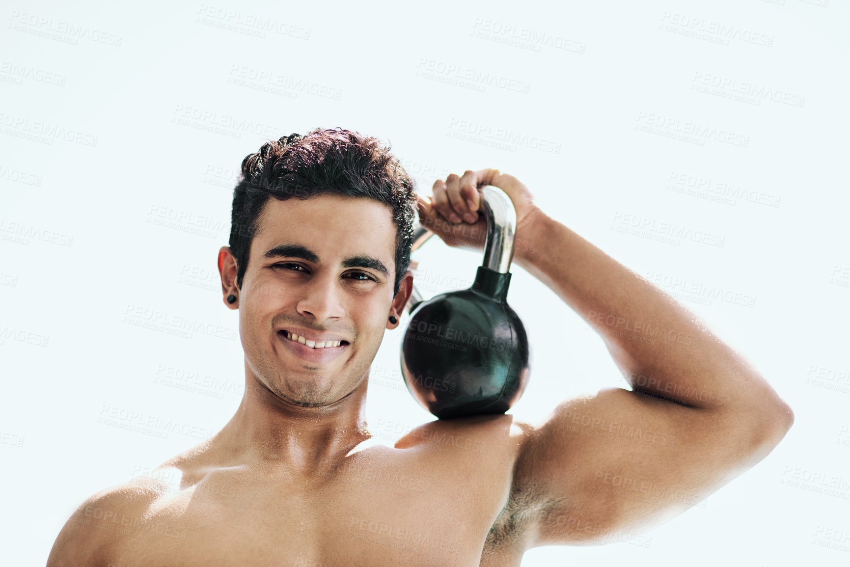 Buy stock photo Portrait of a shirtless young man posing with a kettle bell outside