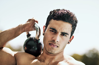 Buy stock photo Portrait of a shirtless young man posing with a kettle bell outside