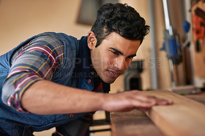 Buy stock photo Carpenter, workshop and man checking wood for home renovation, expert skill and construction startup. Entrepreneur, remodeling and handyman in garage with board for furniture building and diy project