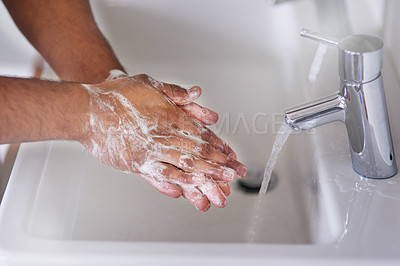 Buy stock photo Cropped shot of a man washing his hands at a bathroom