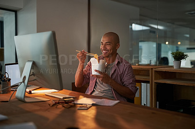 Buy stock photo Cropped shot of a young designer eating takeaways while working late in an office
