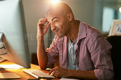 Buy stock photo Cropped shot of a young designer looking confused while working late in an office