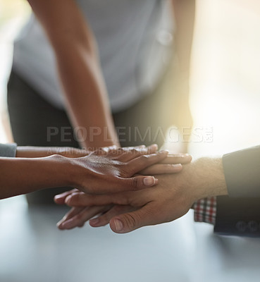 Buy stock photo Shot of a group of unidentifiable businesspeople putting their hands together in the office