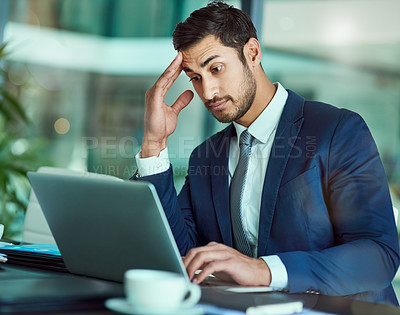 Buy stock photo Shot of an stressed executive working on a laptop in an office