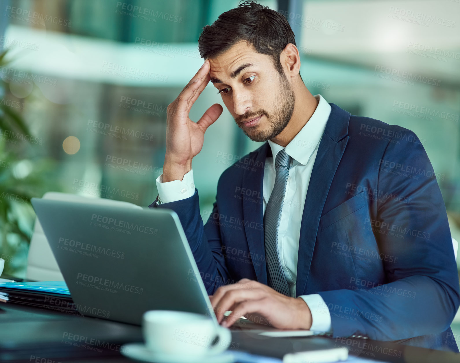 Buy stock photo Shot of an stressed executive working on a laptop in an office