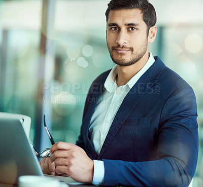 Buy stock photo Portrait of an executive working on a laptop in an office