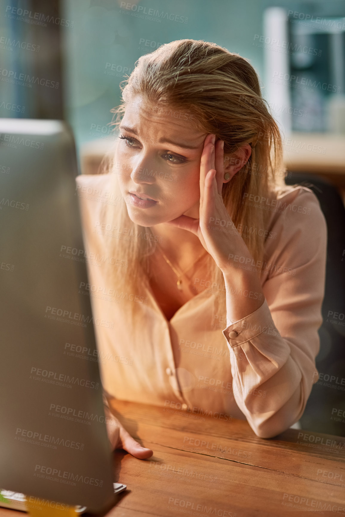 Buy stock photo Shot of an exhausted young businesswoman working on a computer in an office