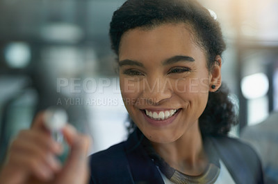 Buy stock photo Shot of a young businesswoman brainstorming on a glass wall in an office