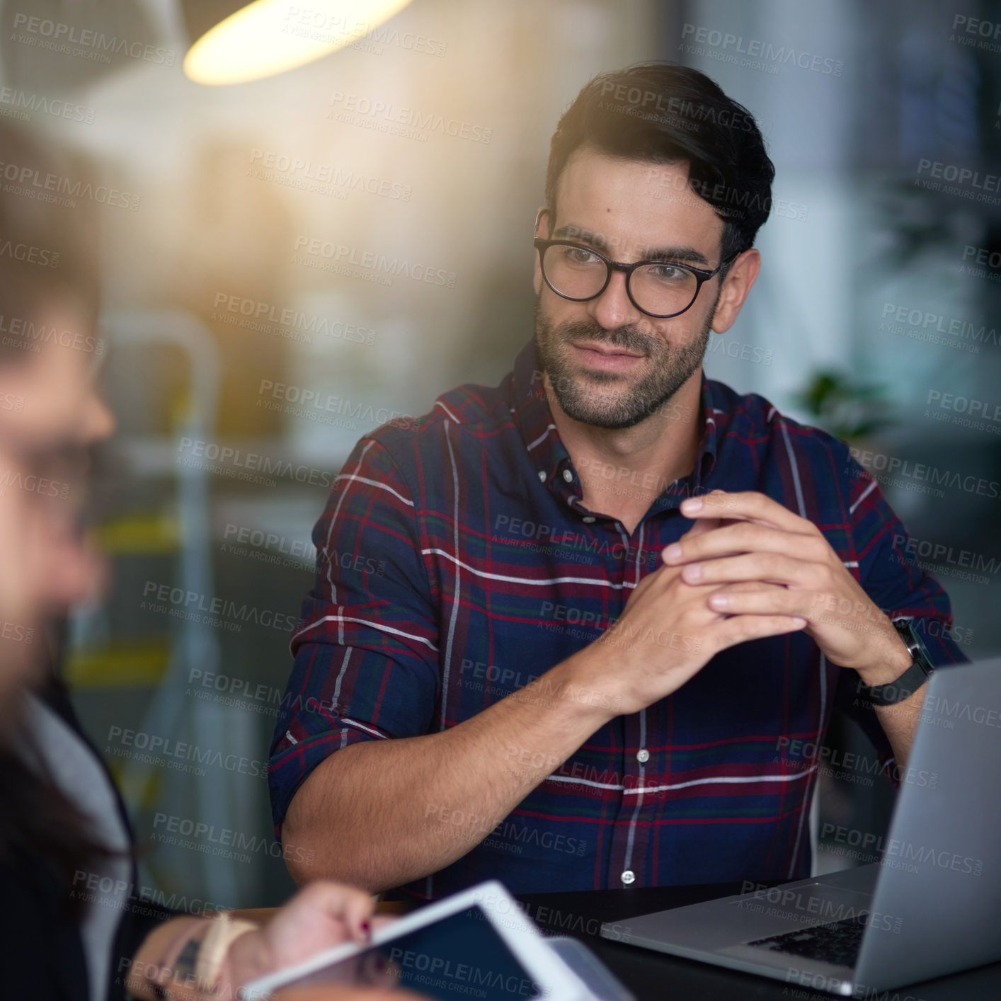 Buy stock photo Shot of an unimpressed businessman listening to his colleague's ideas in the boardroom