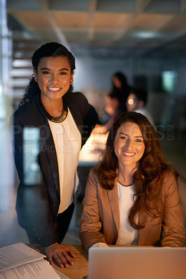 Buy stock photo Portrait of two businesswomen working overtime together in the office