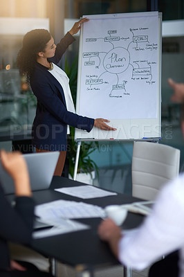 Buy stock photo Shot of a young businesswoman giving a late night presentation in the boardroom