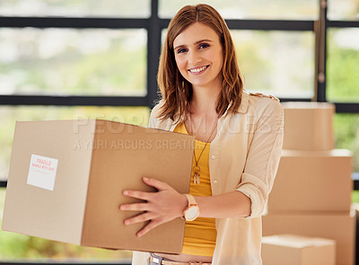 Buy stock photo Portrait of a smiling young woman carrying a box on moving day