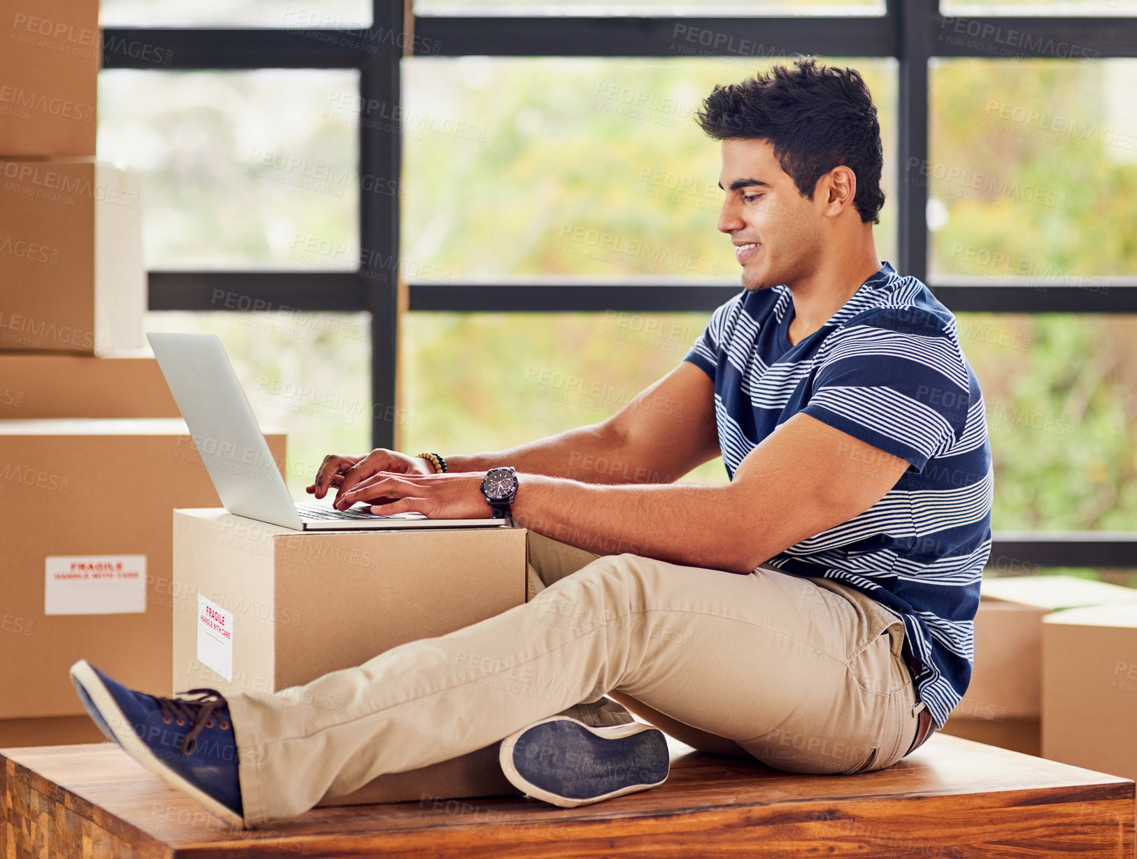 Buy stock photo Happy, man and laptop with boxes for moving day, real estate and house relocation for contact and planning. Smile, male person and tech for email about home investment, mortgage loan and property