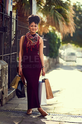 Buy stock photo Cropped shot of a young woman doing some shopping in the city