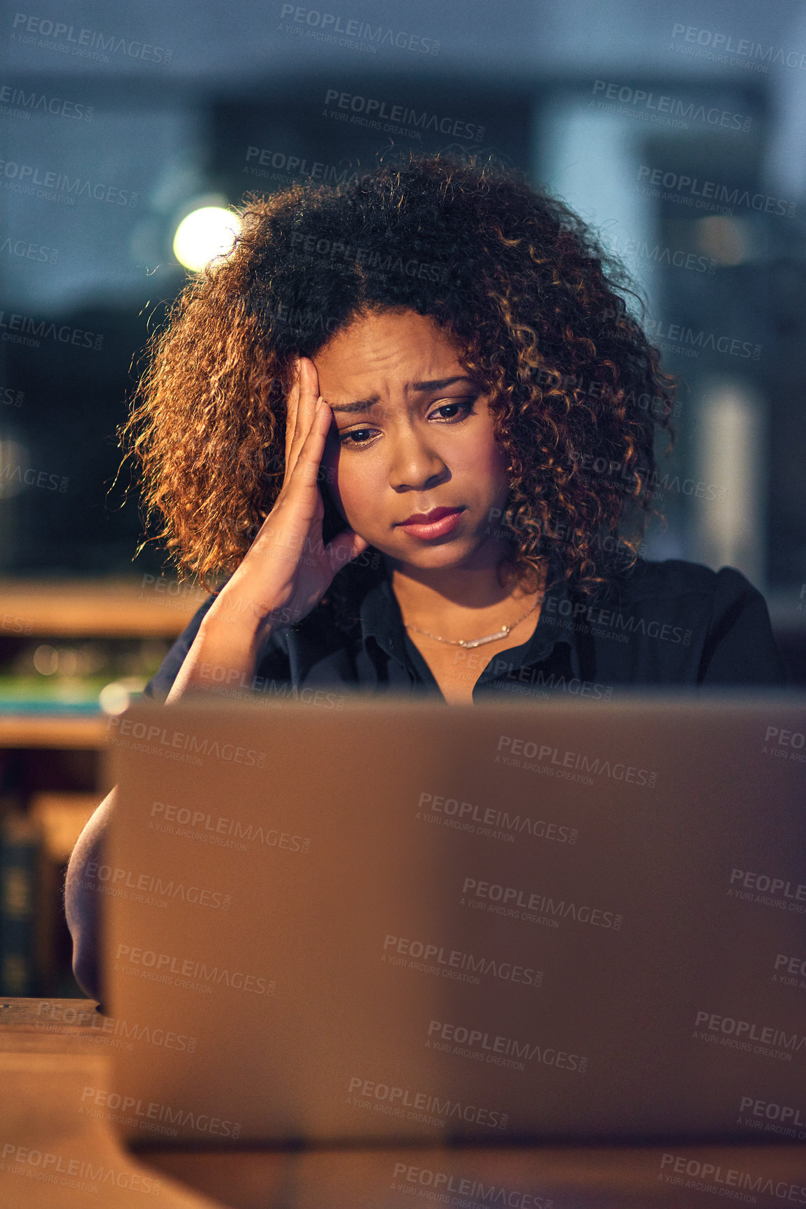 Buy stock photo Shot of a young businesswoman experiencing stress during a late night at work