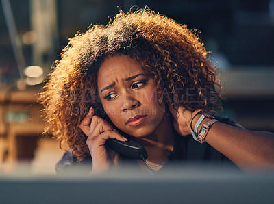 Buy stock photo Shot of a young businesswoman making a stressful phone call during a late night at work
