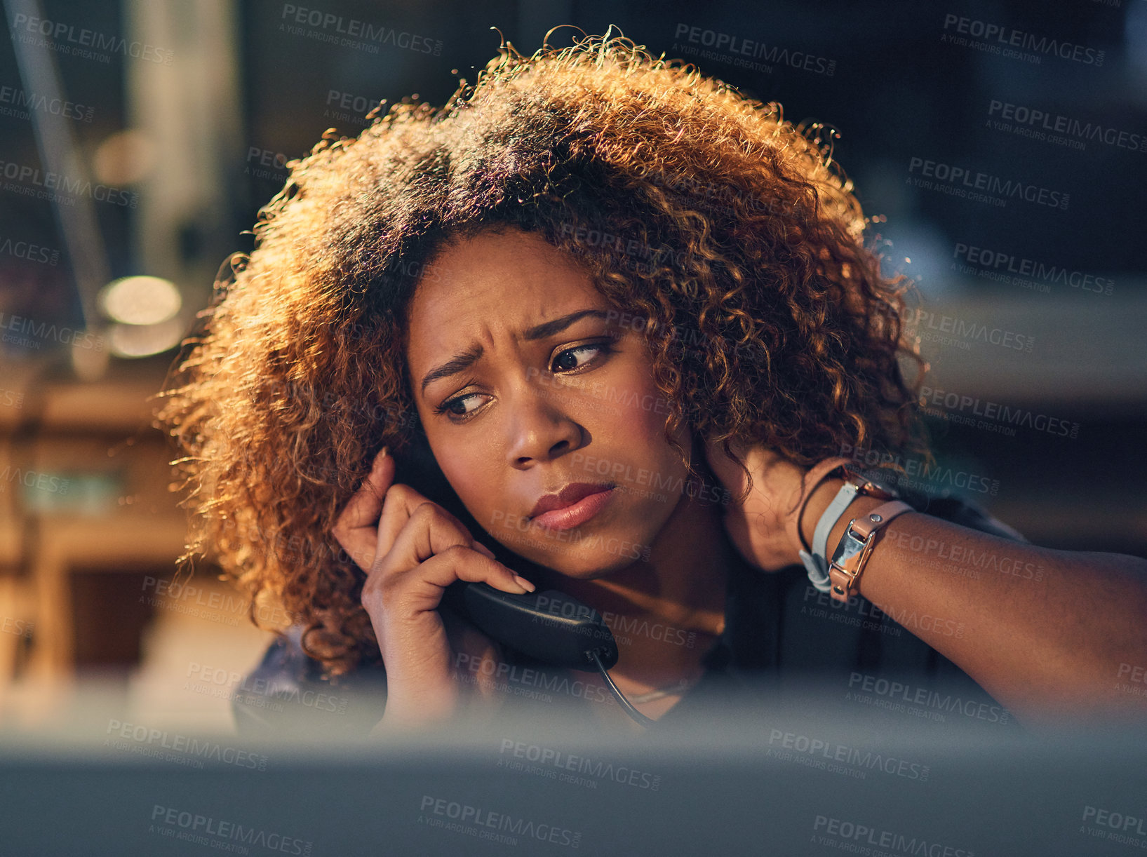 Buy stock photo Shot of a young businesswoman making a stressful phone call during a late night at work