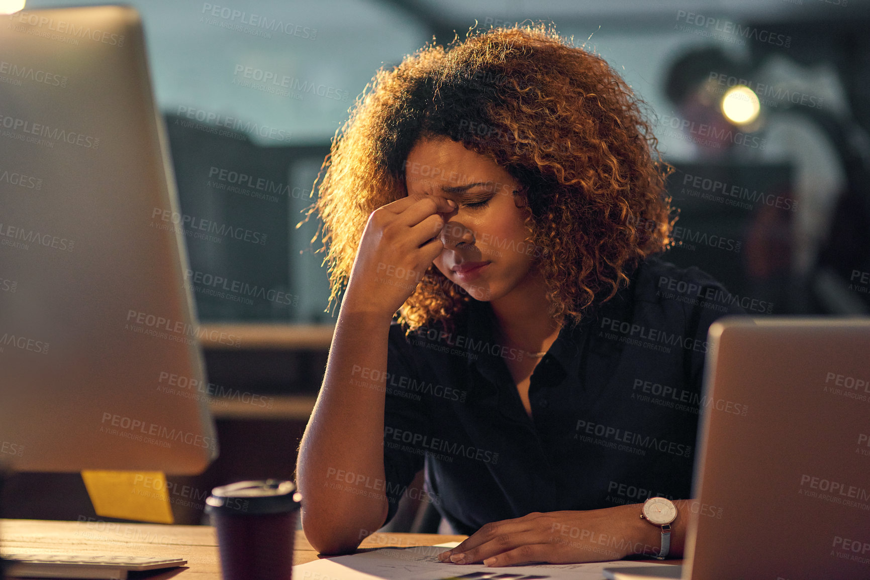 Buy stock photo Shot of a young businesswoman experiencing stress during a late night at work