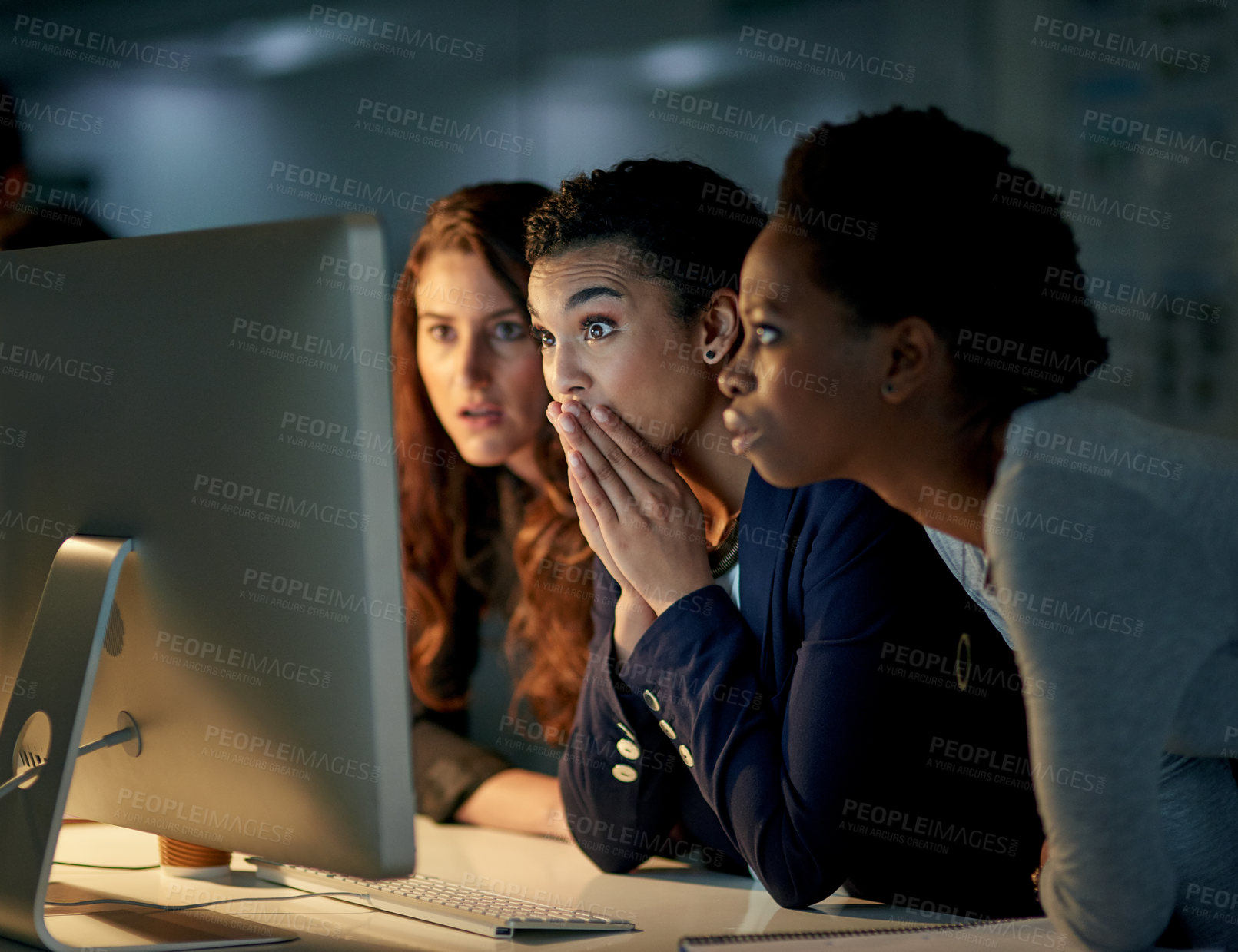 Buy stock photo Cropped shot of a group of colleagues looking shocked while working late in an office
