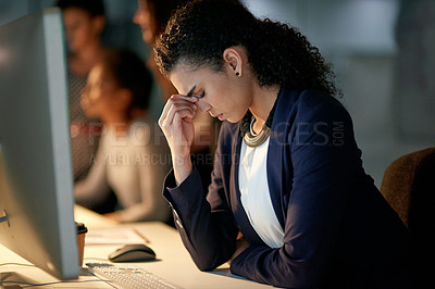 Buy stock photo Cropped shot of a stressed out businesswoman working late in an office