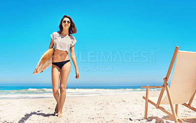 Buy stock photo Portrait of a sexy young woman walking back from the ocean with her surfboard
