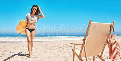 Buy stock photo Rearview shot of a sexy young woman walking back from the ocean with her surfboard