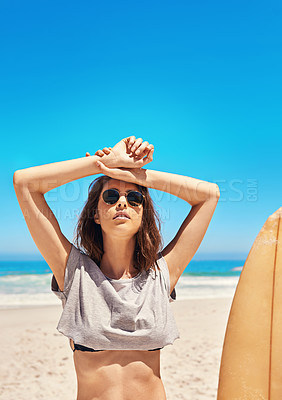 Buy stock photo Portrait of a sexy young woman standing on the beach with her surfboard