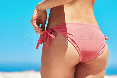 Buy stock photo Shot of a sexy young woman's buttocks on the beach