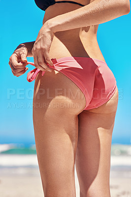 Buy stock photo Shot of a sexy young woman's buttocks on the beach
