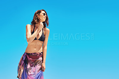 Buy stock photo Shot of a sexy young woman standing on the beach